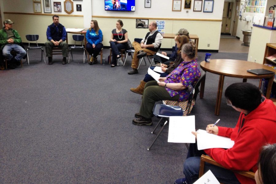 Part of the talking circle at the town hall meeting in the SHS library on Jan. 14. At left, Galena Mayor John Korta is next to Galena Supt. Chris Reitan; others pictured are GILA counselor Jana Rider, admissions director Adrian Johnson, GILA principal John Riddle, several  community members, and Hawk Highlights staff writer Aaron Munter.  		