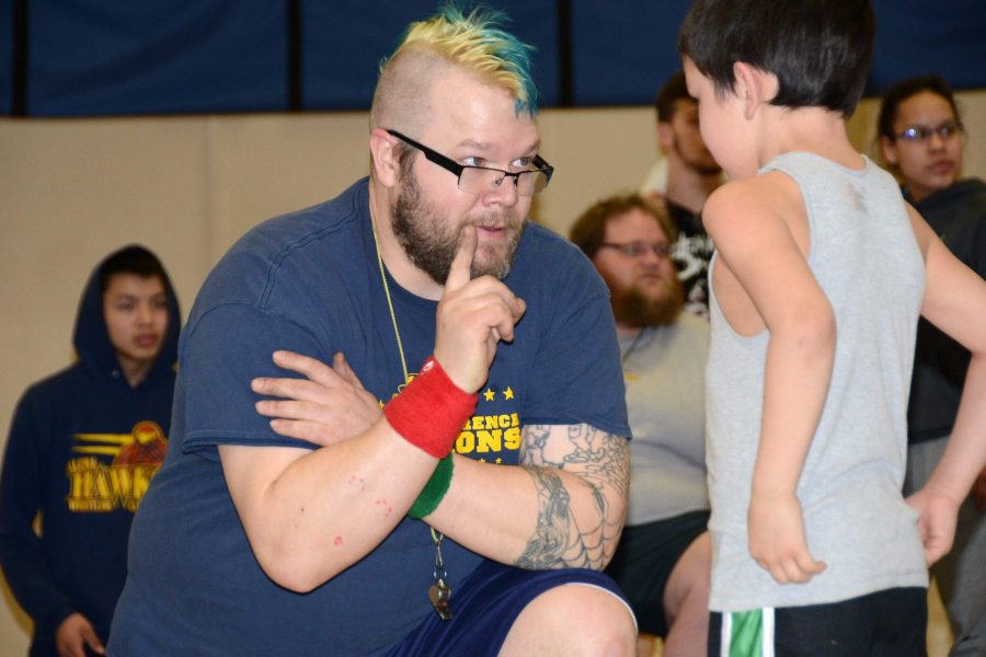 Coach Josh Pittsenbarger talks with one of the Little Hawks wrestlers during last years Intersquad Rumble.