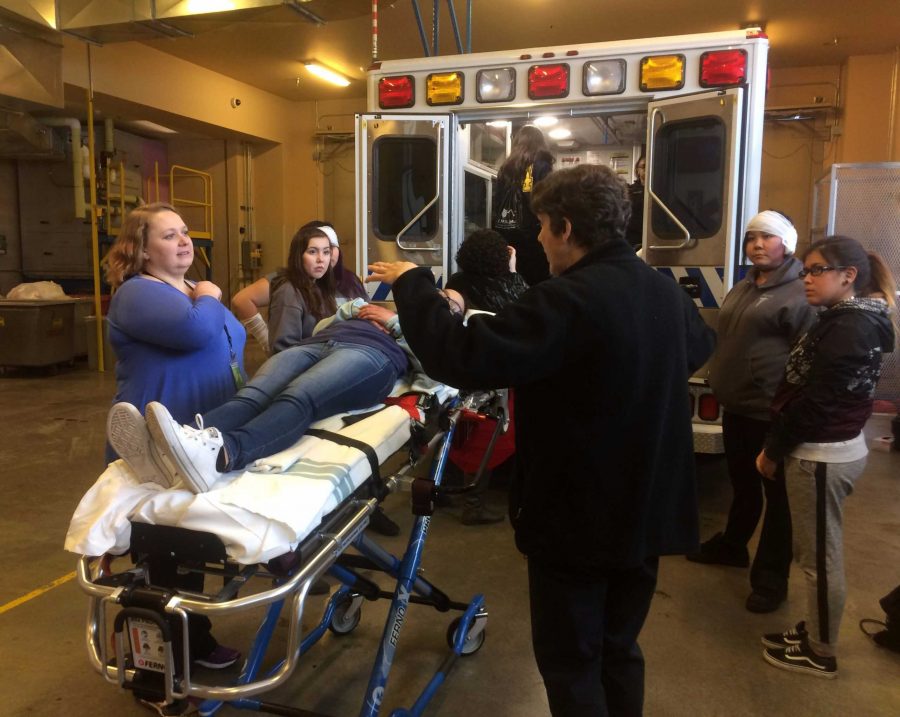 Health sciences teacher Carrie Given, in the blue, were shown the skills needed for paramedics working in an ambulance during their recent visit to Fairbanks for the AHEC conference.