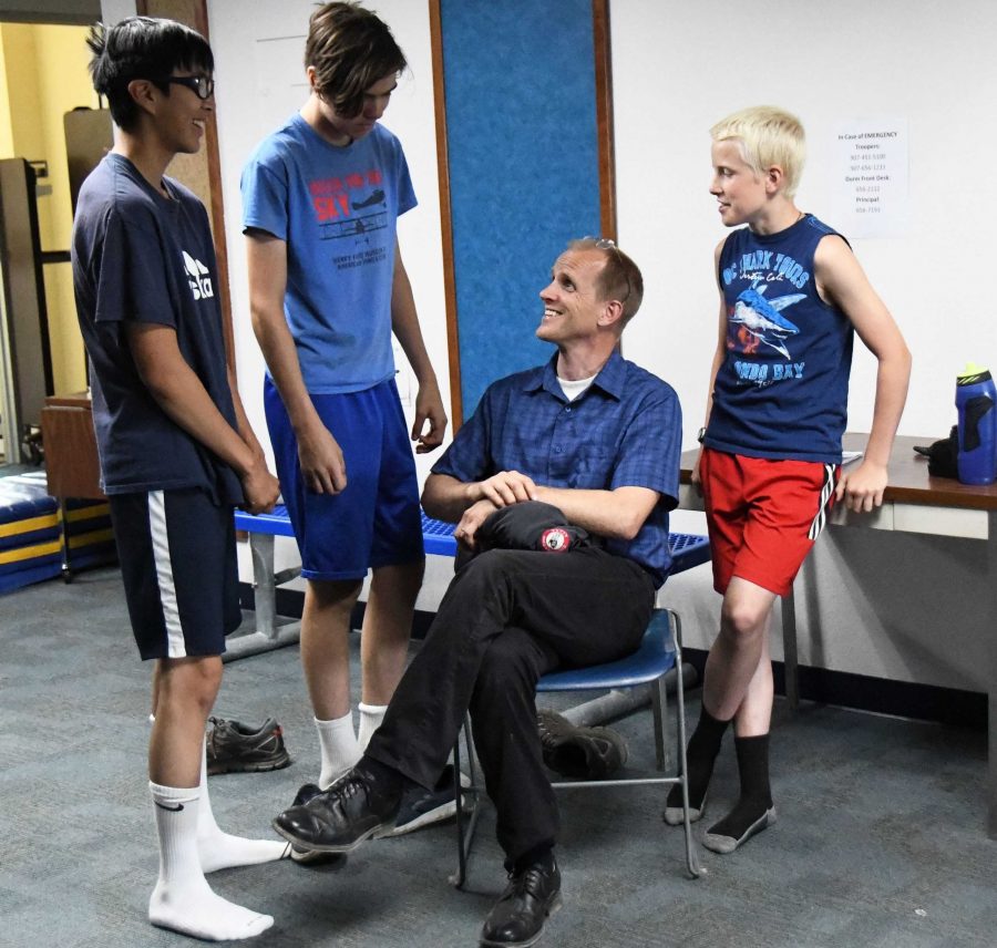Mr. Merriner talks with members of the Galena Hawks cross-country team this summer.